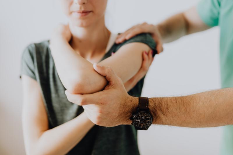 A chiropractor performing chiropractic adjustment on a patient