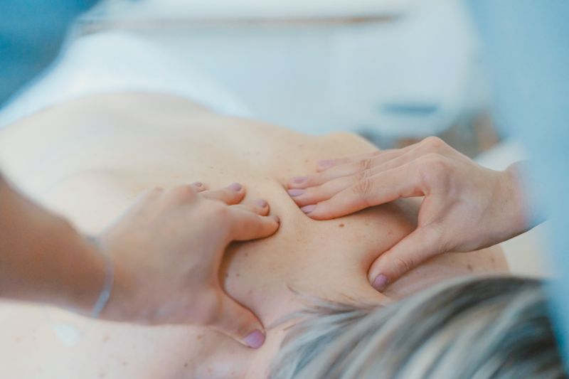 Person lying down receiving a back massage