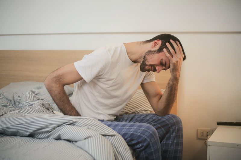 Does chiropractic help migraines - a man getting out of bed with a migraine